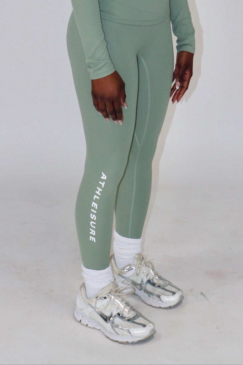 Person wearing a green athletic outfit with 'Aeriform' branding on a white background