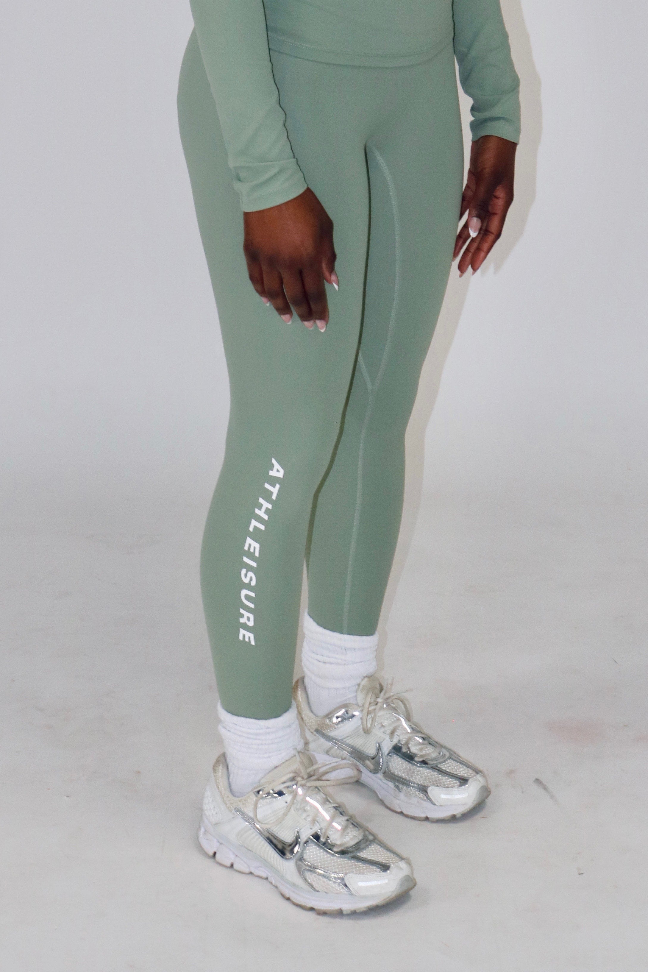 Person wearing a green athletic outfit with 'Aeriform' branding on a white background